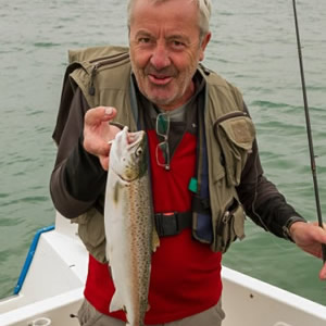 An angler from Dublin with a lovely sea trout taken fishing close to Bartragh Island. July 2014.