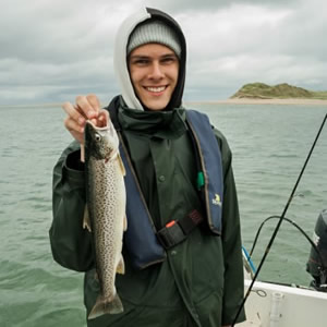 A young angler with a good trout, taken on sandeel bait. July 2014.