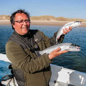 A young angler with a good trout, taken on sandeel bait. July 2014.